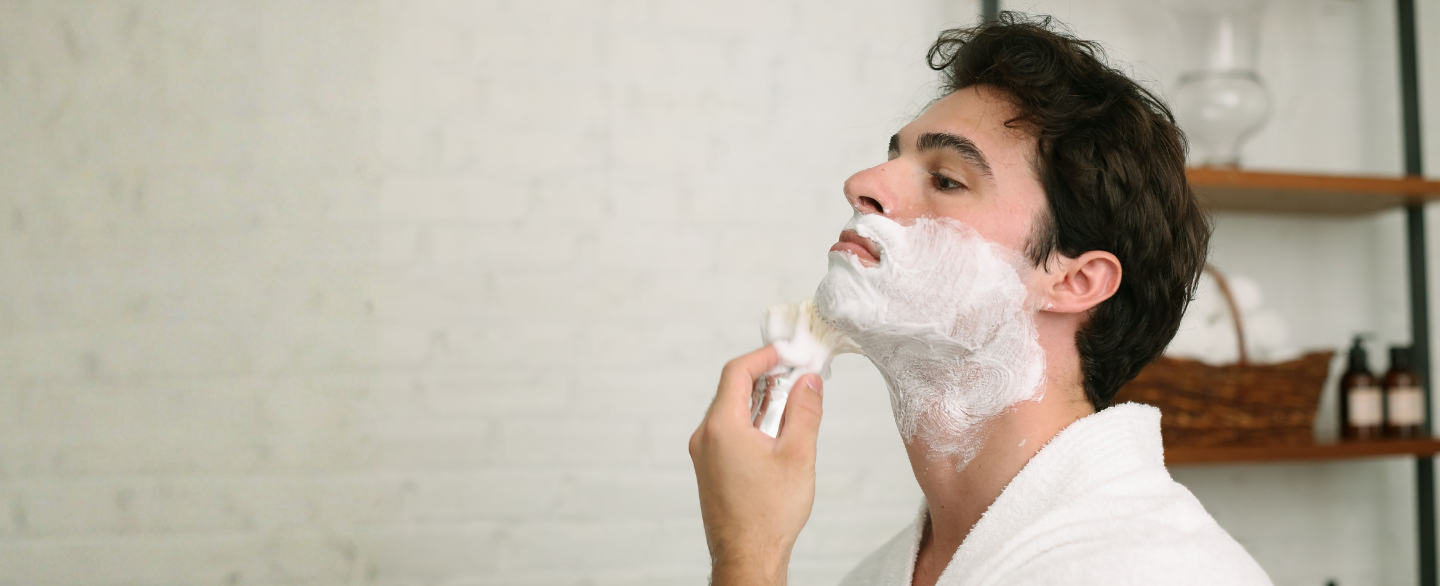 Man applying shave cream to his face with our Professional Shave Brush