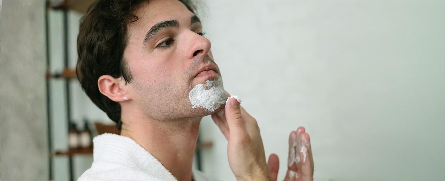 Man applying Pre-Shave Cream to chin