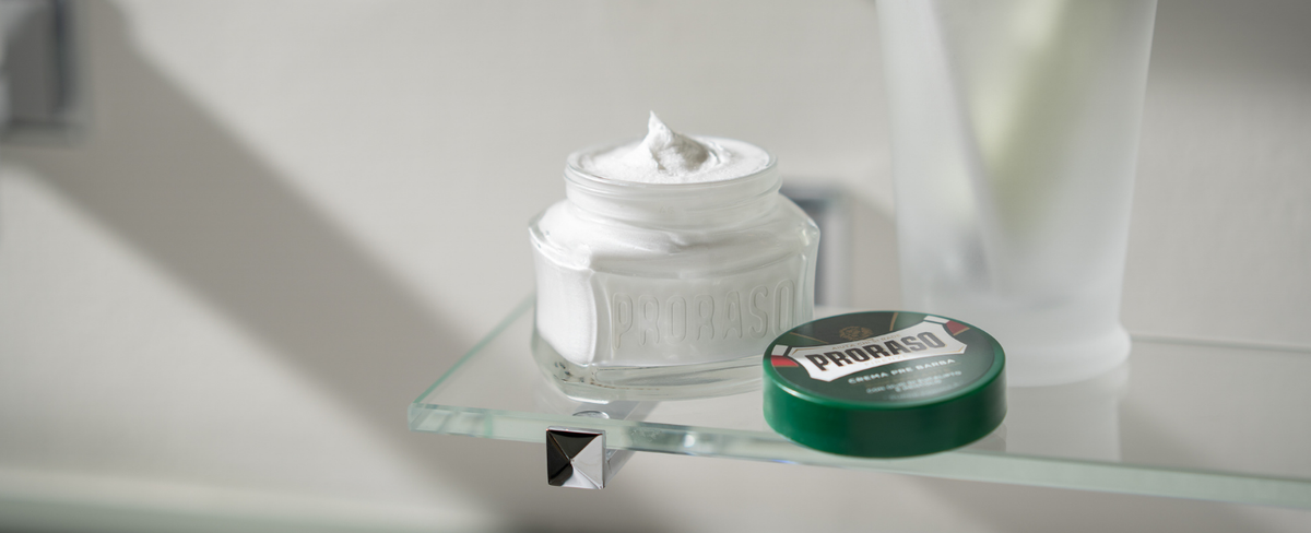 Jar of Refreshing Formula Pre-Shave Cream open on a bathroom shelf