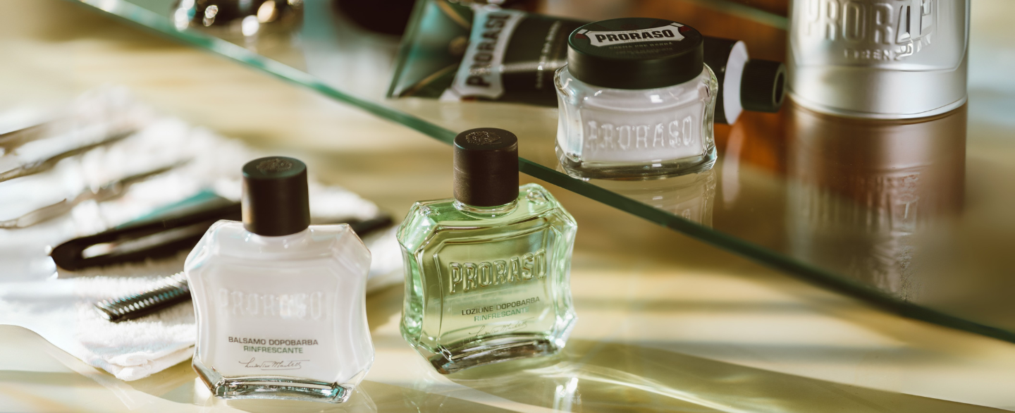 Refresh Shave lineup on barber counter with After Shave Balm, After shave Lotion, Pre-Shave Cream and Shave Cream Tube