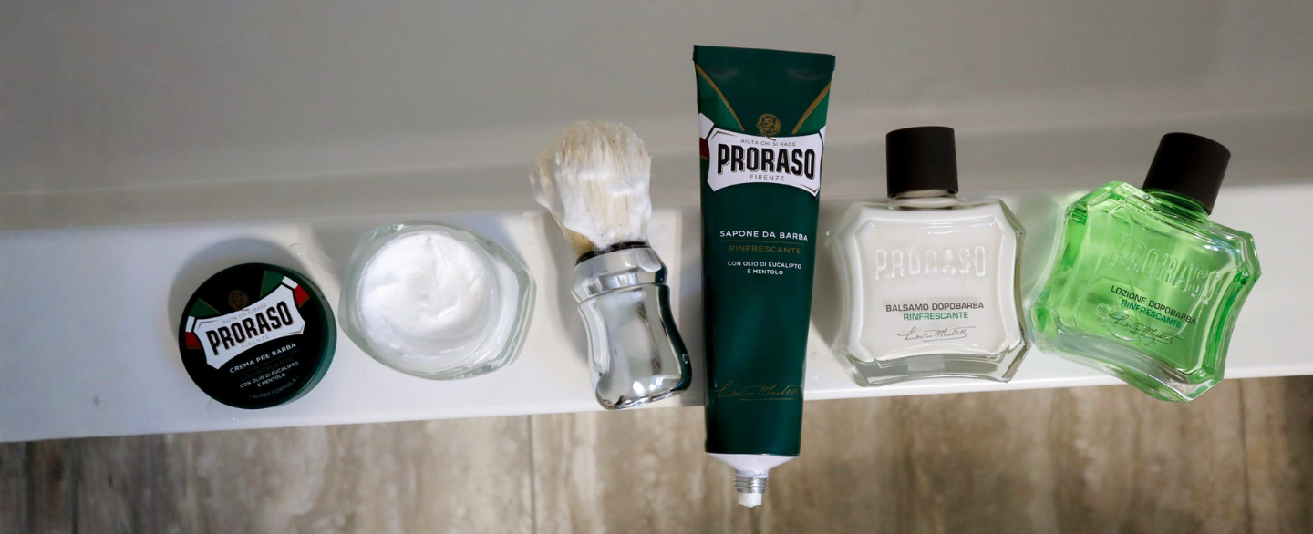Refresh Formula steps sitting on bathtub edge- Pre-Shave Cream, Professional Shave Brush, Shave Cream Tube, After Shave Balm and After Shave Lotion