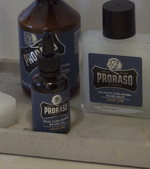 Proraso Beard Care Tin Azur Lime: Includes Beard Wash, Beard Balm and Beard Oil on counter.