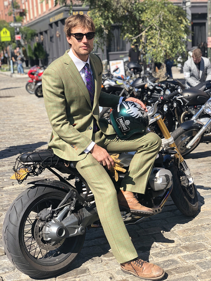 Man on motorcycle holding Proraso Helmet