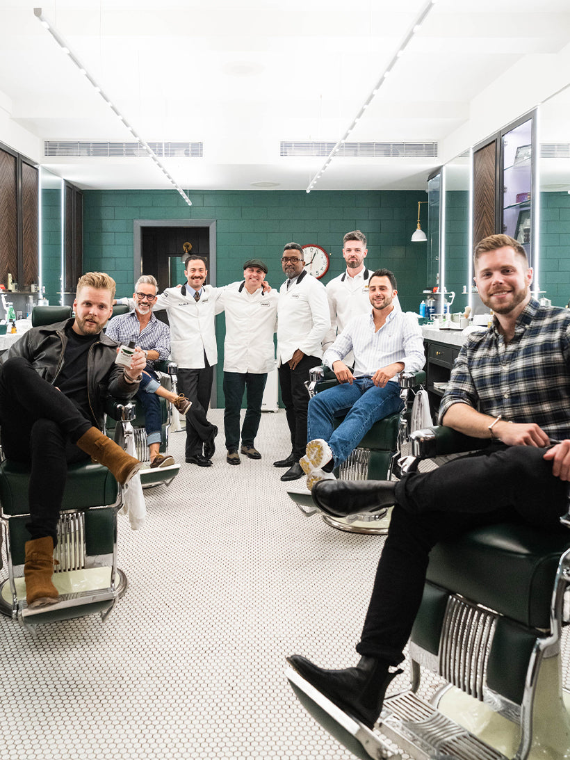 Image of 8 men getting ready for their Proraso class sitting in barber chairs at Haar & Co. Barbershop in New York City