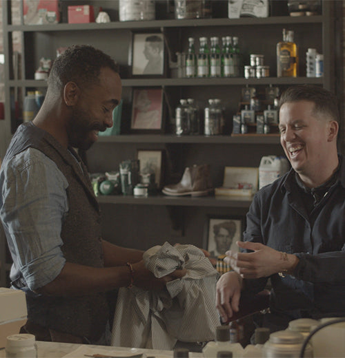 Barber Woody sitting, consulting with friend and business partner Ian in the Barbershop Club in LA.