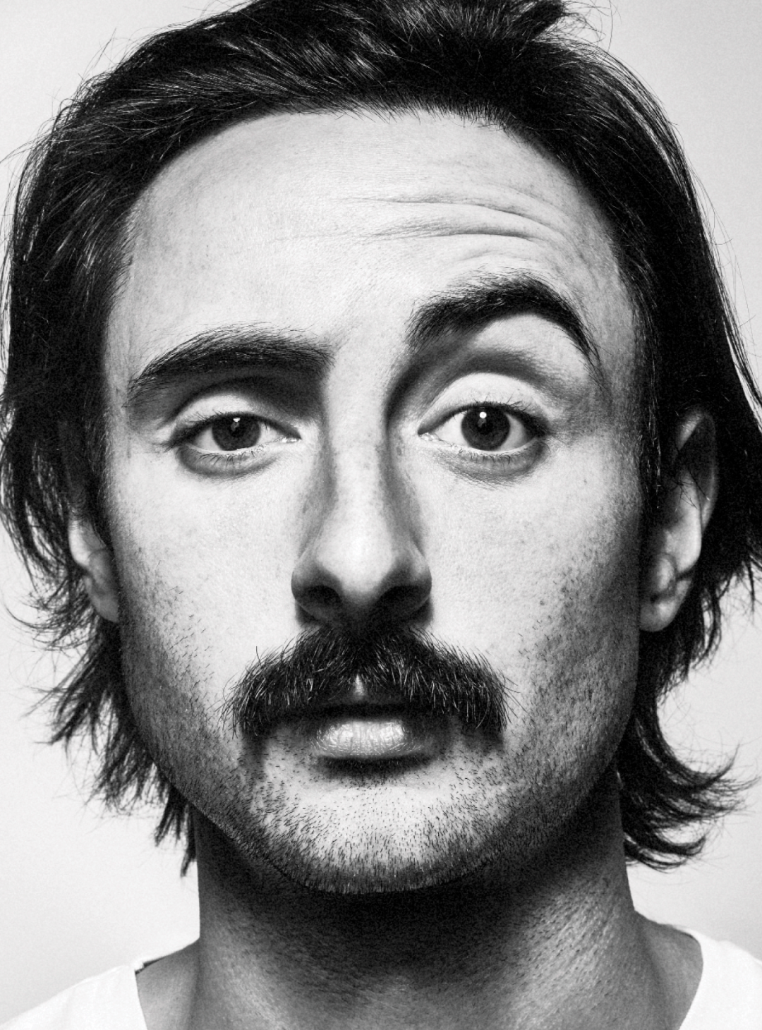 Man with thick moustache and messy hair