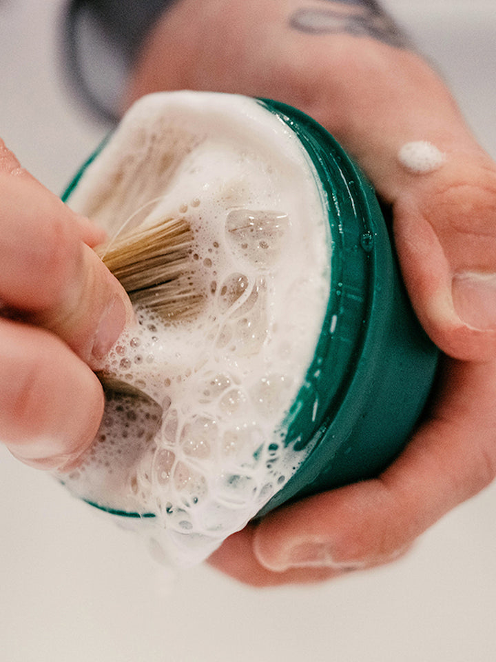 A lather: Proraso brush in shaving cream tub