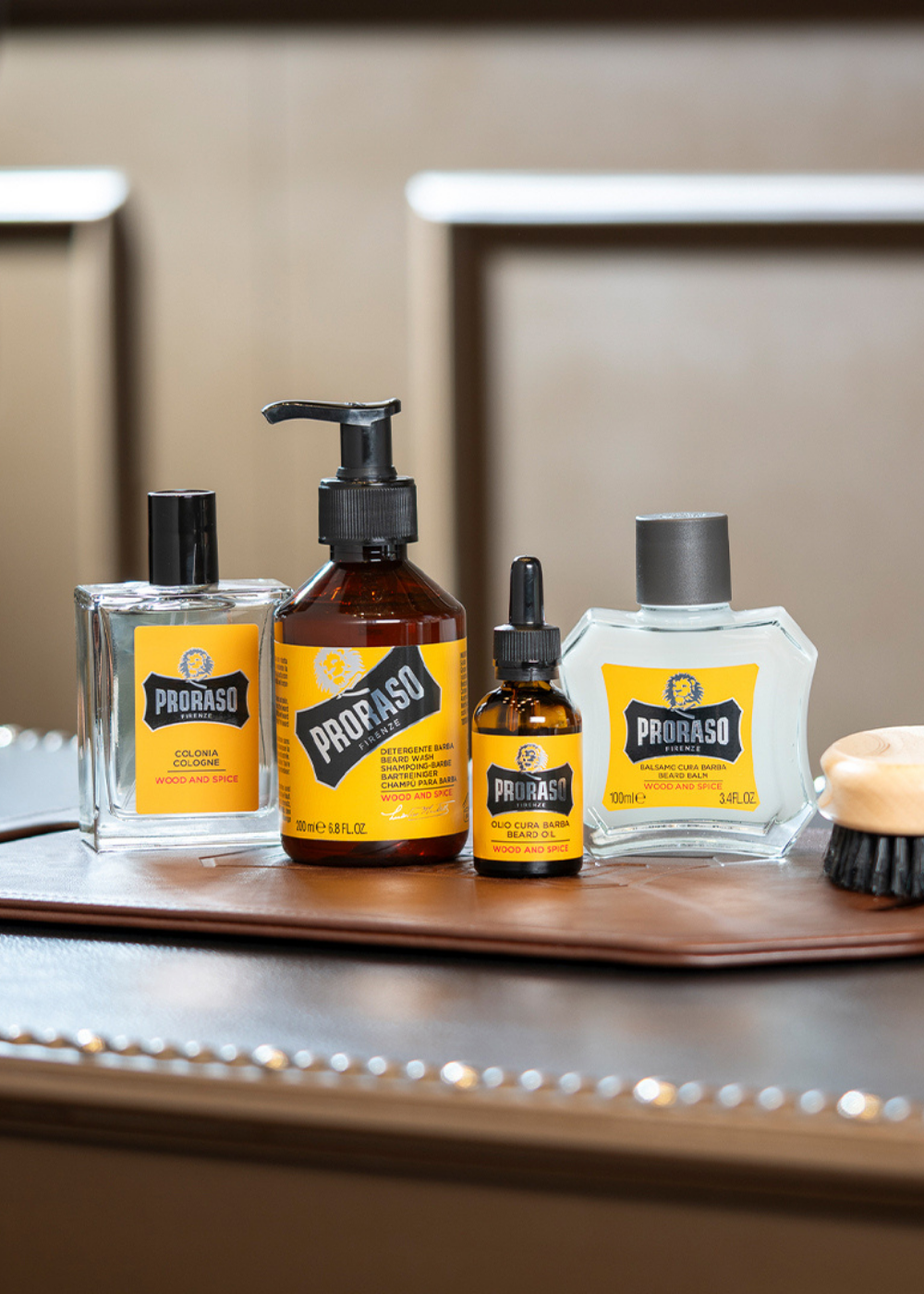 Wood & Spice Beard collection: Cologne, Beard Wash, Beard Oil  and Beard Balm on a leather tray with a brush.