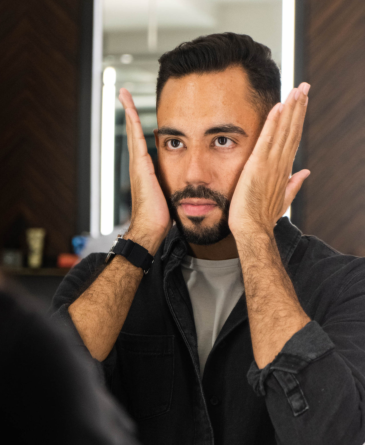 Man with short beard applying Beard Balm