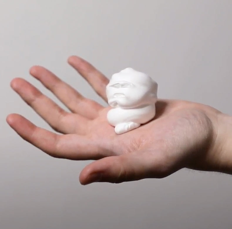 Large dollop of shave foam sprayed out on a man's hand to show thick texture