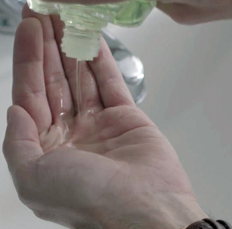 Refresh After Shave Lotion being shook into palm of hand.