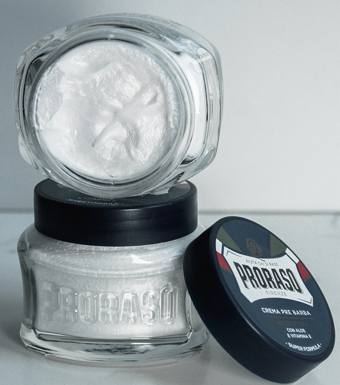 Jar of Protective Pre-Shave Cream with lid open to show texture on top of a closed Protective Pre-Shave Cream jar