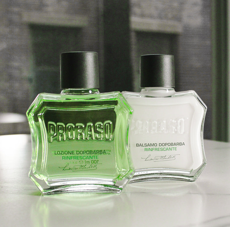 Refresh After Shave Lotion and After Shave Balm sitting next to each other on a white marble table in front of a window