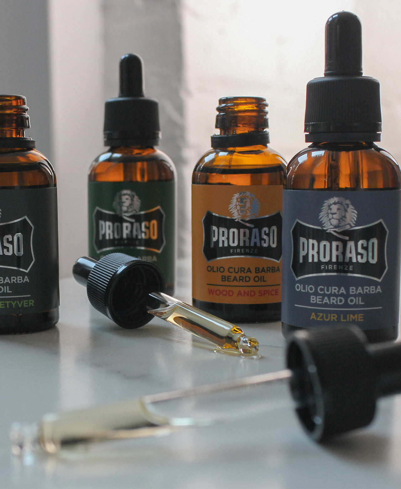 Full Beard Oil line up left to right : Cypress & Vetyver, Refreshing, Wood & Spice and Azur Lime with two droppers open