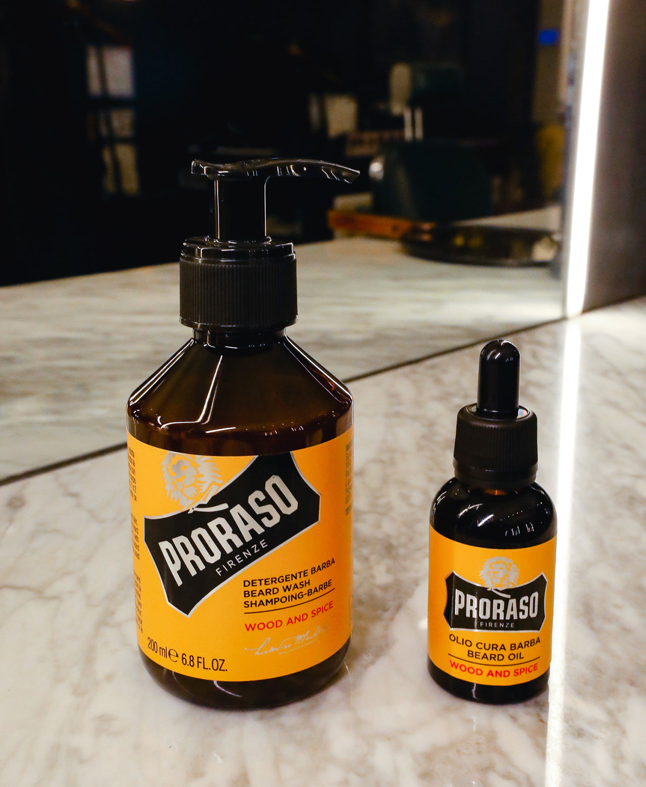 Wood & Spice Beard Wash and Beard Oil sitting on barbershop counter with mirror in background