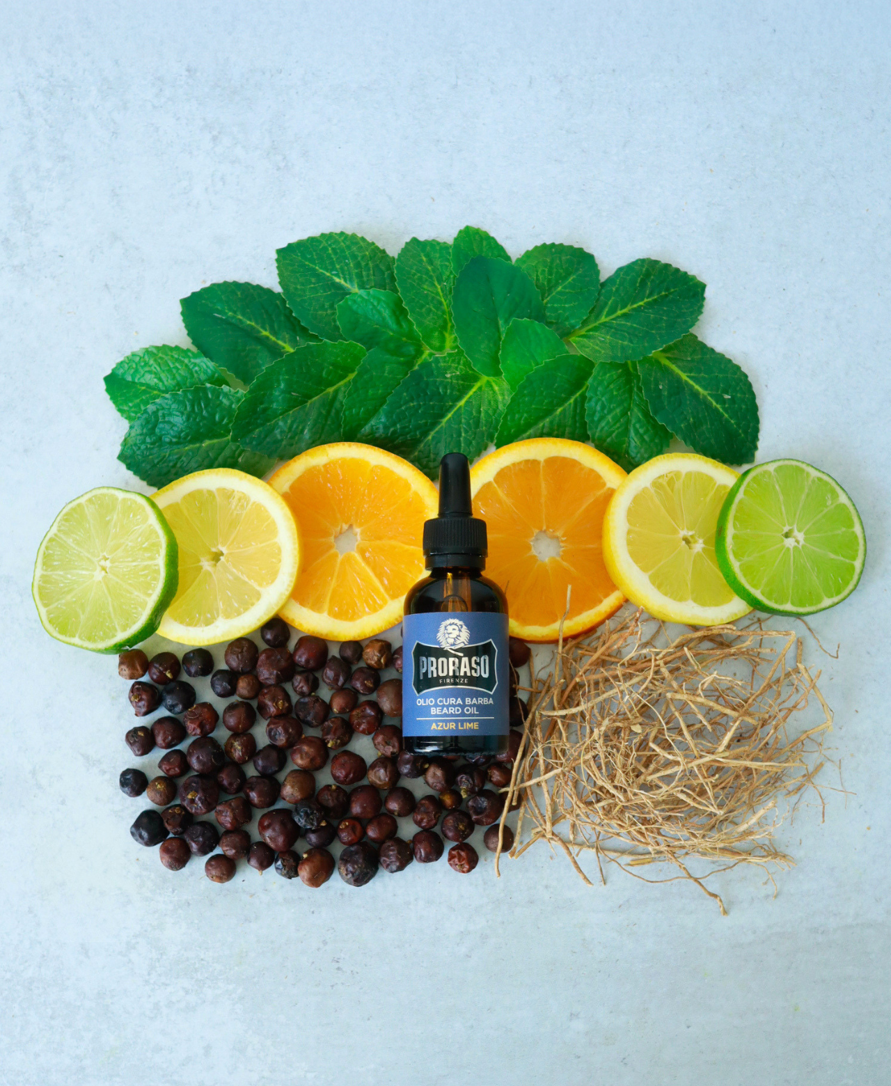 Beard Oil in Azur Lime Fragrance laying on top of fragrance notes: Patchouli, Citrus, Juniper Berries and Moss.