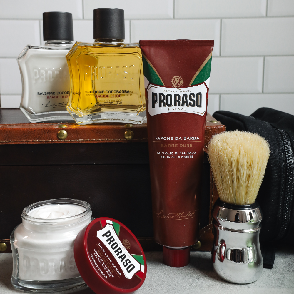 Full Proraso Nourishing lineup in front of a white tile background. Including Nourishing Pre-Shave Cream, Shave Cream Tube, After Shave Balm, After Shave Lotion and Professional Shaving Brush