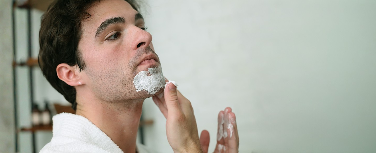 Many applying Pre-Shave Cream to bottom of face