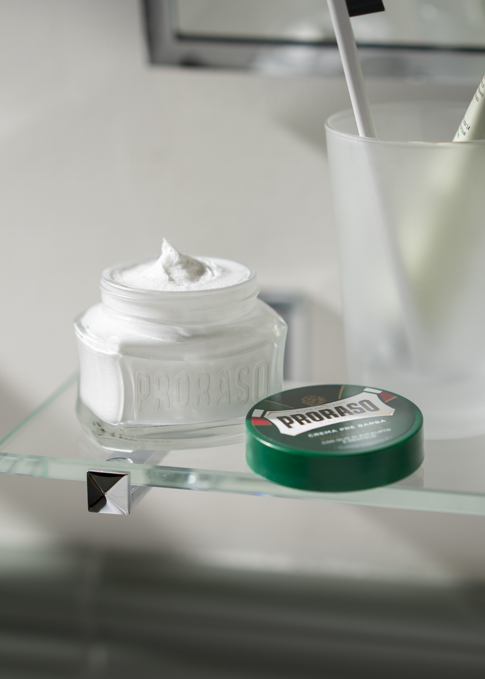 Jar of Refreshing Formula Pre-Shave Cream open on a bathroom shelf