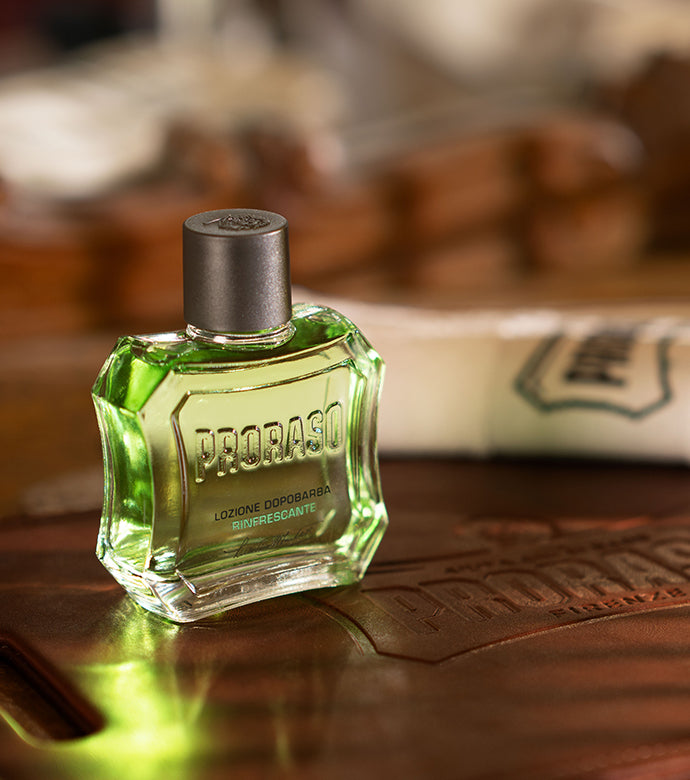 Refreshing After Shave Lotion bottle on dark wood table with Proraso towel in background