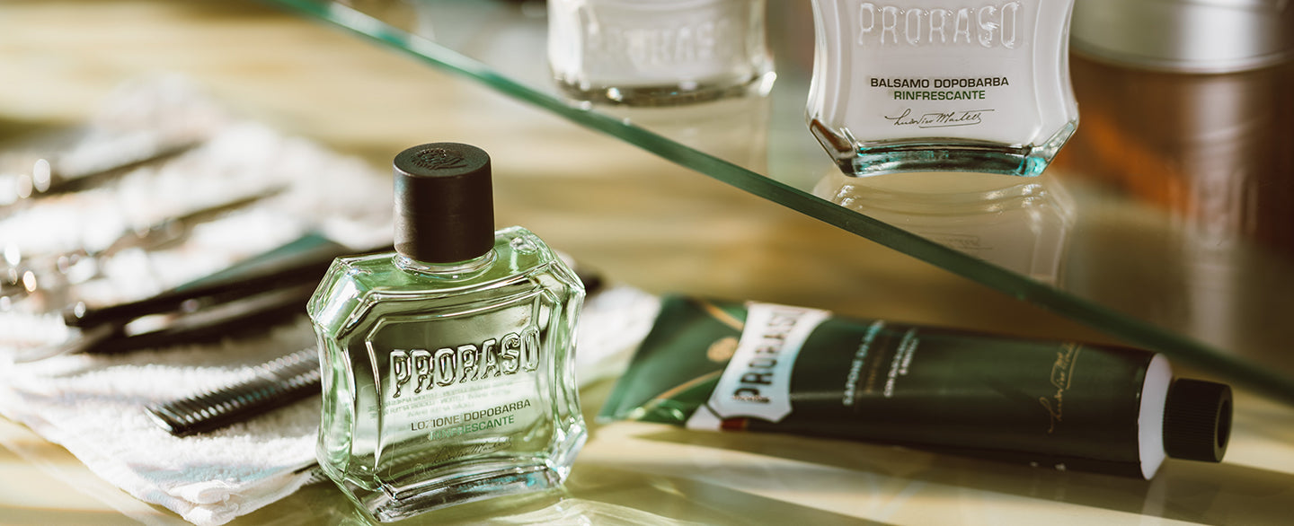 Proraso Refreshing Formula After Shave Balm, Shave Cream Tube and After Shave Balm sitting at a barber station