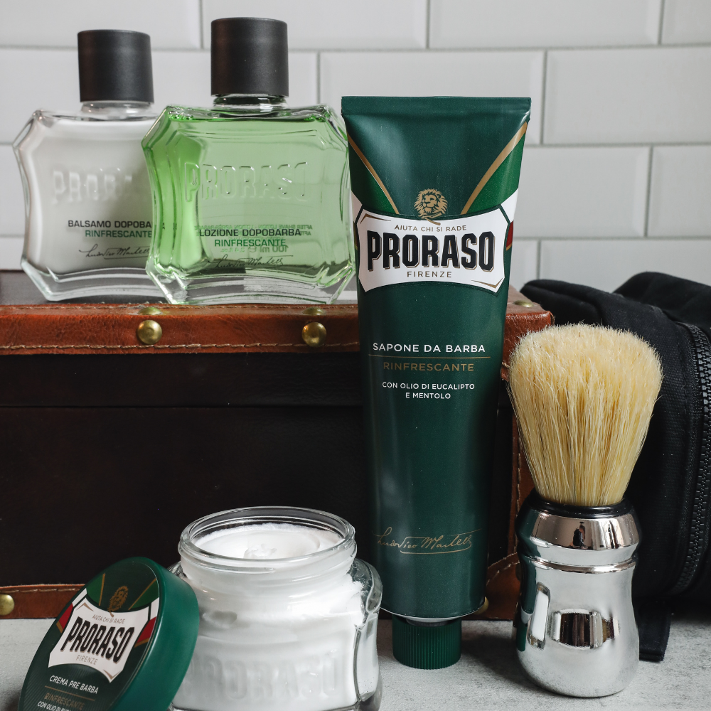 Full Proraso Refreshing lineup in front of a white tile background. Including Refreshing Pre-Shave Cream, Shave Cream Tube, After Shave Balm, After Shave Lotion and Professional Shaving Brush