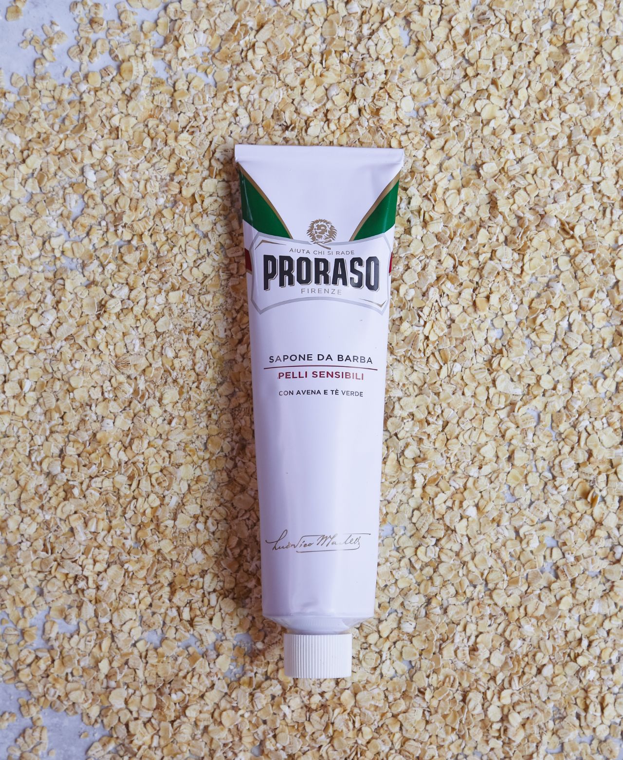 Sensitive Shave Cream Tube sitting on oatmeal