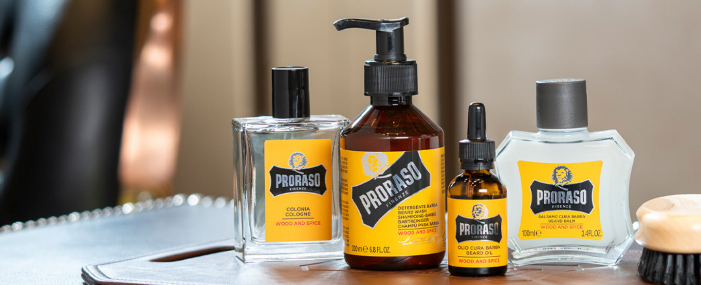 Wood & Spice Beard collection: Cologne, Beard Wash, Beard Oil  and Beard Balm on a leather tray with a brush.