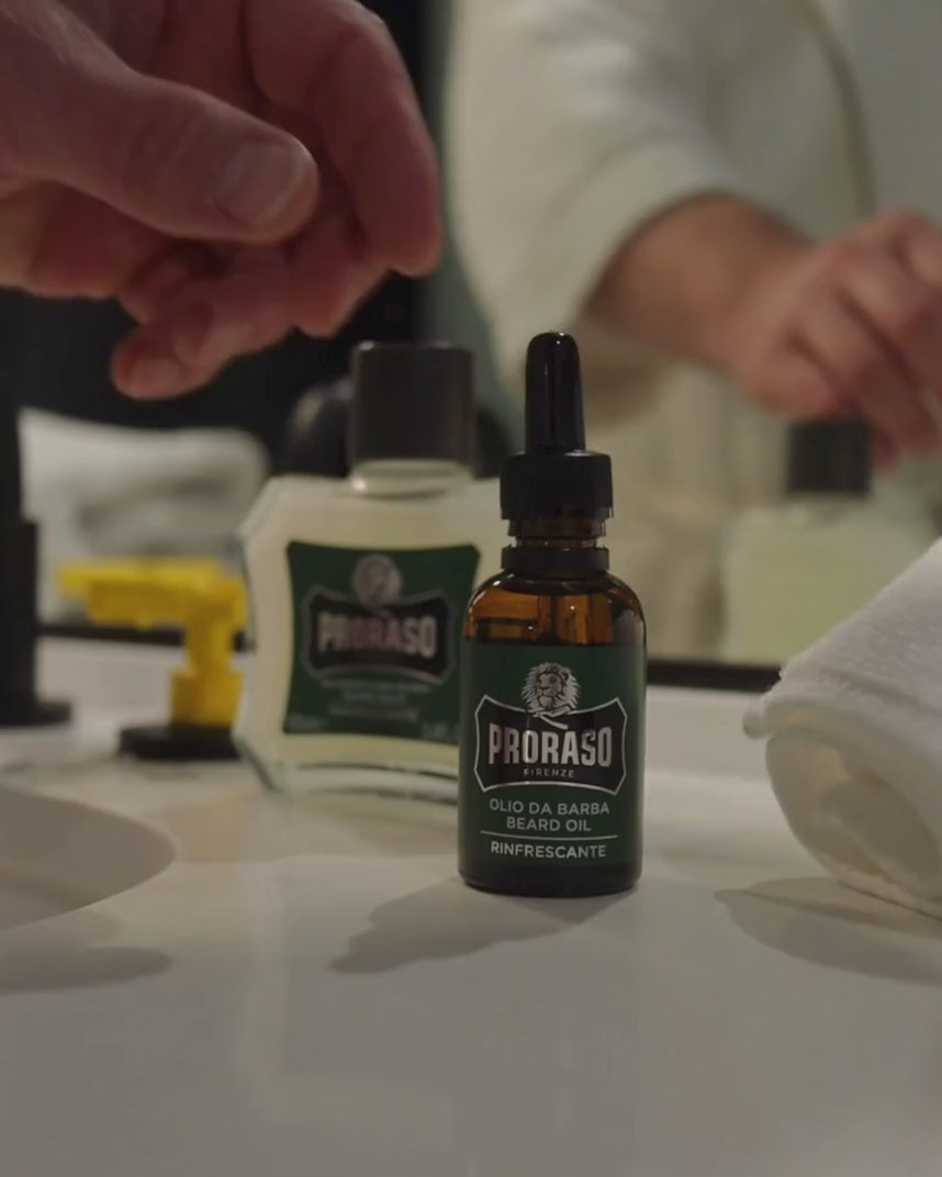 Man applying Beard Oil in Refreshing Fragrance to his thick beard.