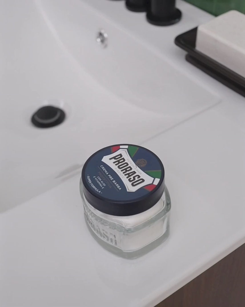 Man scooping and applying Pre-Shave Cream Protective for Dry Skin to face 