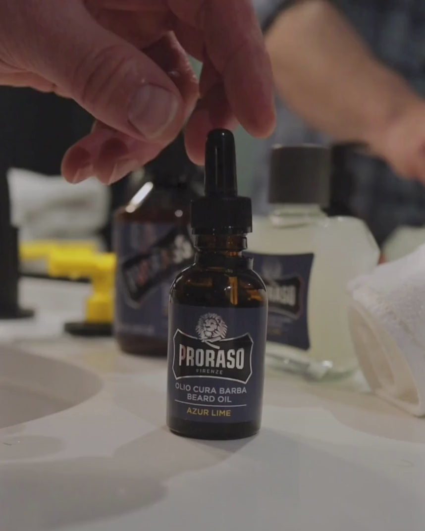 Man with full, thick beard applying Beard Oil in Azur LIme Fragrance to beard.