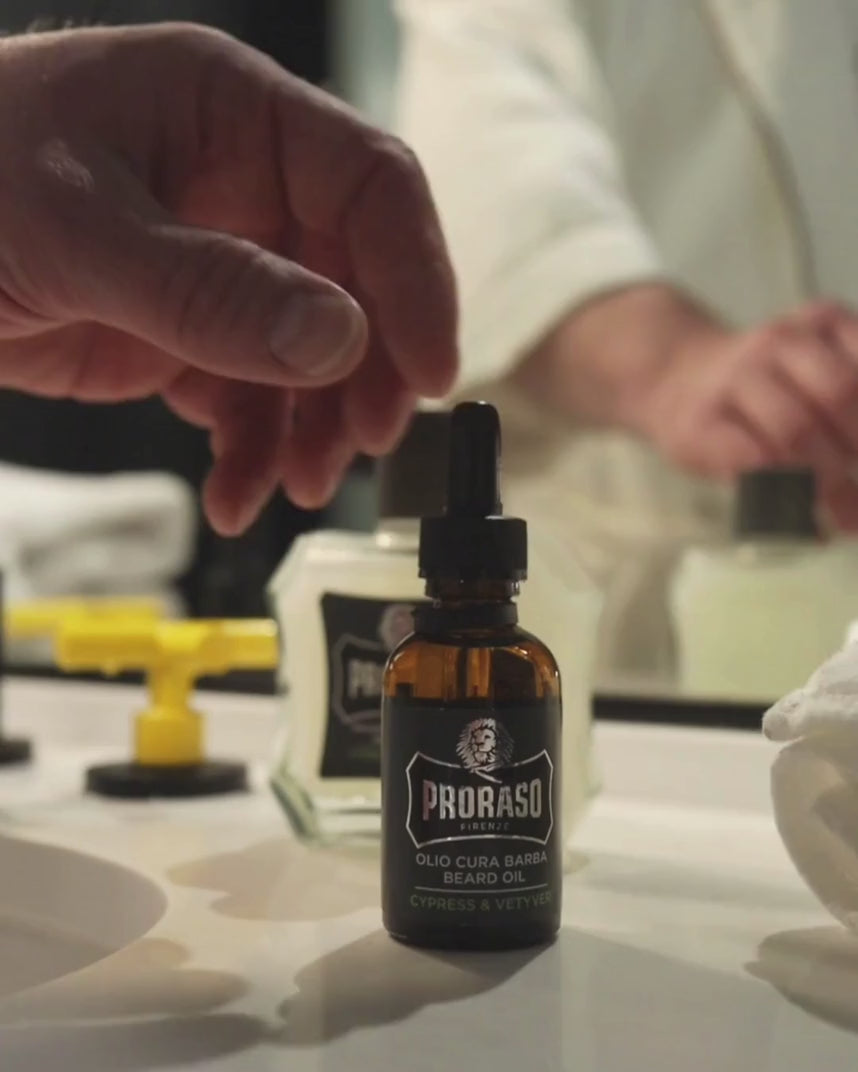 Man applying Beard Oil in Cypress & Vetyver Fragrance to his thick beard.