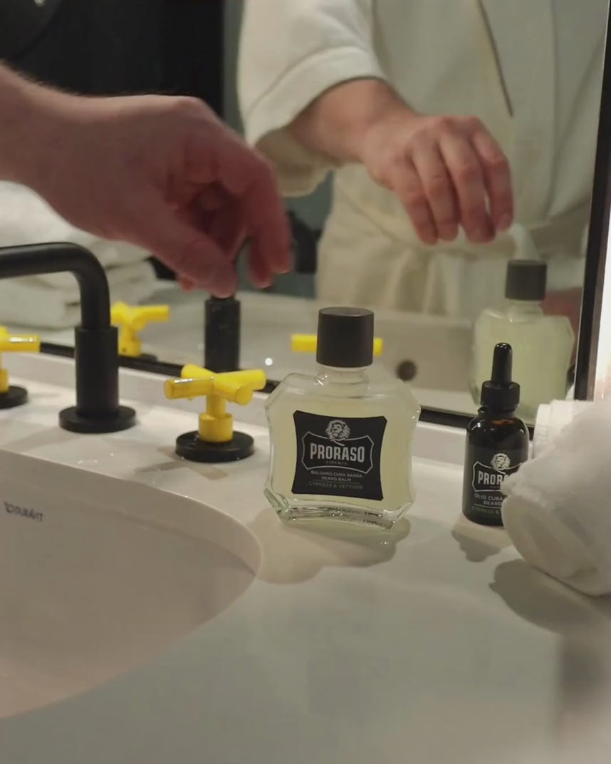Man applying Beard Balm in Cypress & Vetyver Fragrance to his short beard.