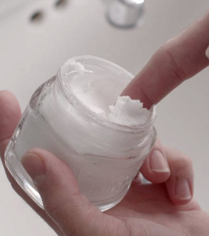 Proraso Refresh Pre-Shave Cream being scooped out of jar over bathroom sink.