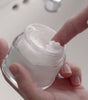 Proraso Refreshing Pre-Shave Cream being scooped from jar showing thick cream texture.