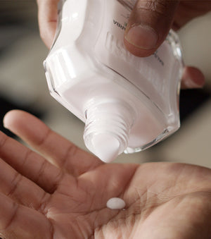Proraso Protective After Shave Balm being poured into palm of hand.