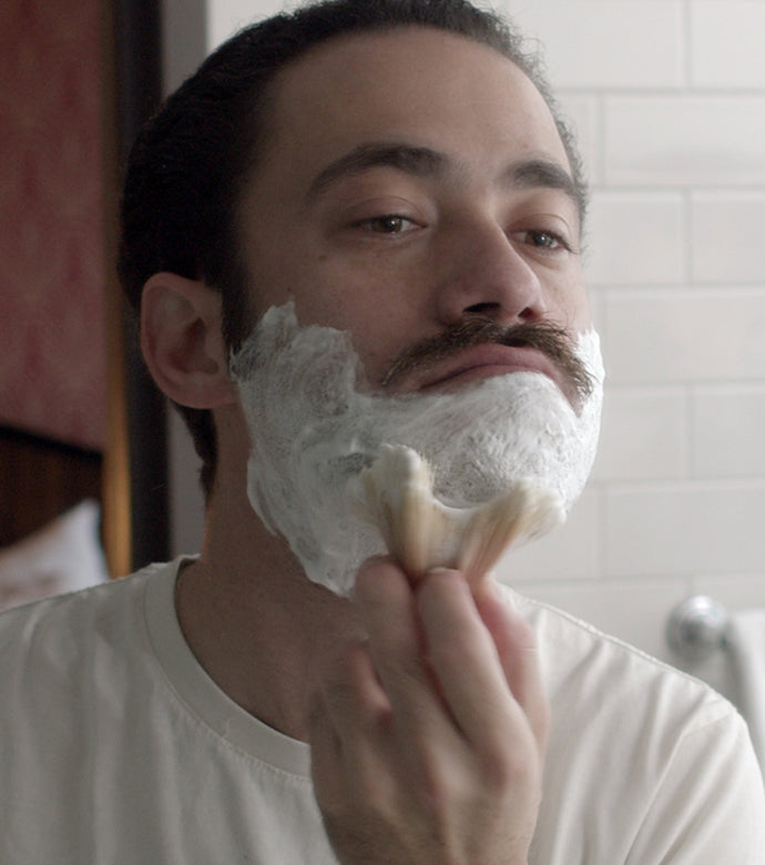 Proraso Refreshing Shave Cream Tube being applied to face with Proraso Professional Shaving Brush