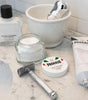 Proraso Sensitive Shave items on bathroom counter: Proraso Sensitive Pre-Shave Cream, Proraso Sensitive Shaving Cream Tube, Proraso Sensitive After Shave Balm with shave bowl, Proraso Professional Shave Brush ad Safety Razor.