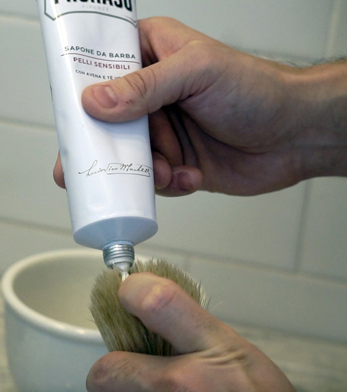 Proraso Sensitive Shave Cream Tube being squeezed onto Proraso Professional Shaving Brush to make thick lather. 