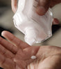 Proraso After Shave Balm being poured into palm of hand.