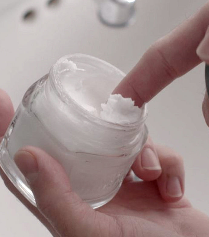 Proraso Refreshing Pre-Shave Cream being scooped from jar, showing thick texture.