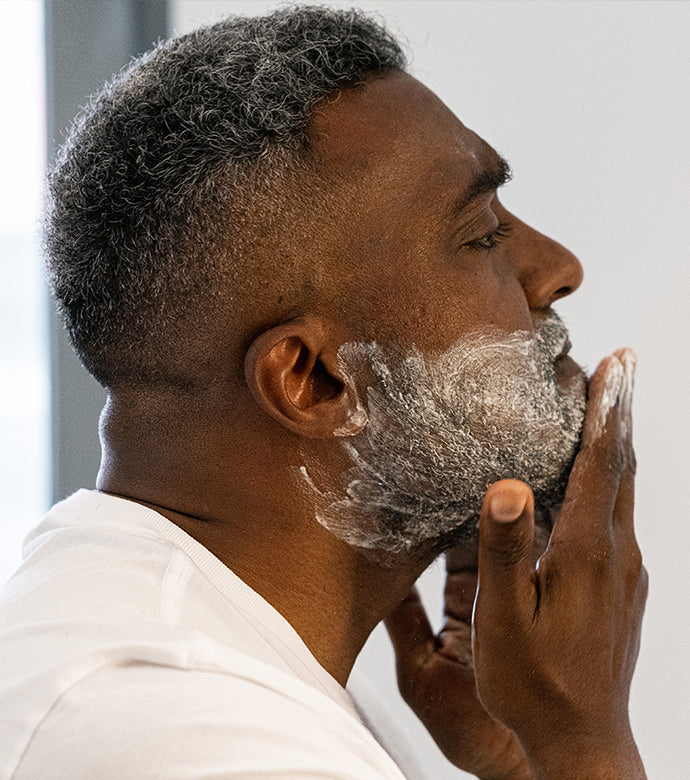 Proraso Sensitive Pre-Shave Cream being applied to the bottom have of face before applying shave cream.