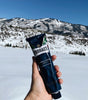 Proraso Protective Shave Cream Tube held in hand with snowy mountains in the background.  Protective formula is perfect for when you need a bit of extra moisture..