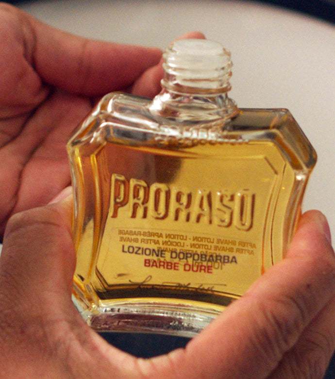 Proraso Nourishing for Coarse Beards After Shave Lotion being held in hand.