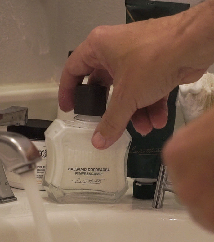 Proraso Refreshing After Shave Balm on bathroom counter.  Shake out a dime-sized amount into palm and apply after shaving.