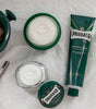 Proraso Refreshing Shaving Soap in a Bowl on the counter with Proraso Refreshing Pre-Shave Cream, Proraso Refreshing Shave Cream tube and shave mug with Proraso Professional Shave Brush.