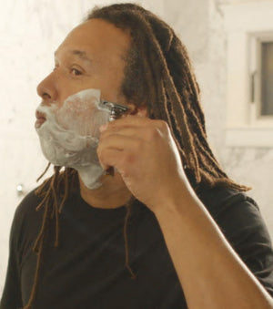 Proraso Nourishing for Coarse Beards Shaving Soap in a Bowl on face being shaved off.