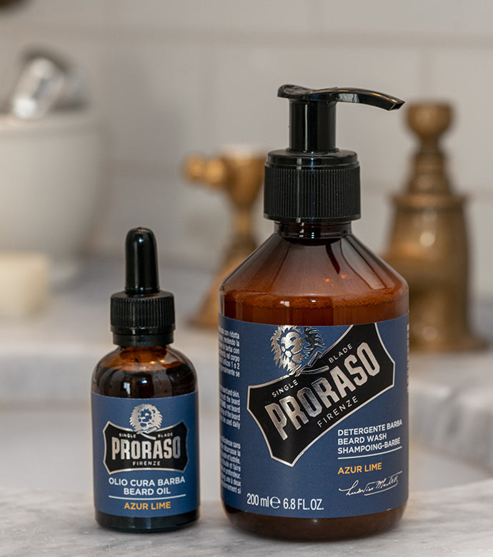 Proraso Azur Lime Beard Oil and Beard Wash sitting on the side of a bathroom sink.
