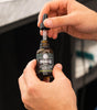Proraso Cypress & Vetyver Beard Oil open in hands.