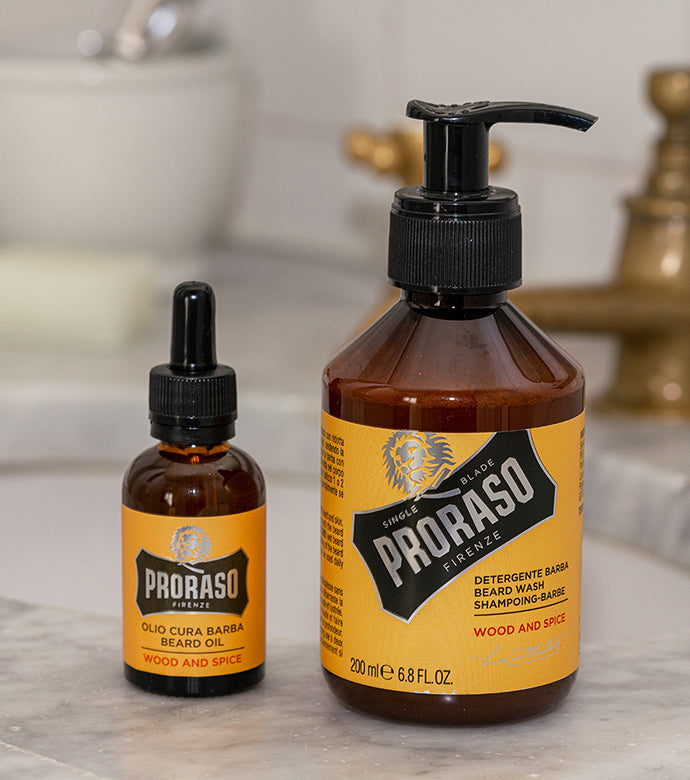 Proraso Wood & Spice Beard Oil and Wood & Spice Beard Wash sitting on the bathroom counter.